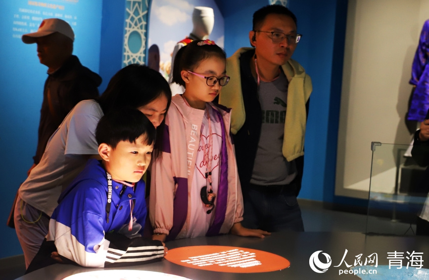 家長帶著小朋友參觀文物。實(shí)習(xí)生 張秀青攝